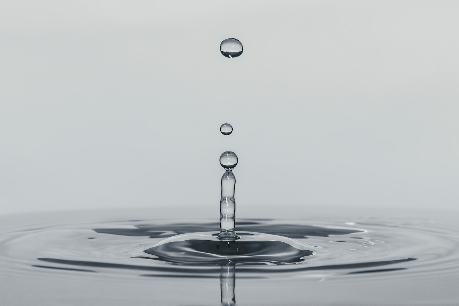 a drop of water falling into a body of water