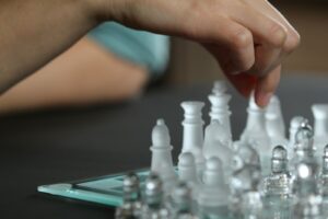 person touching chess piece