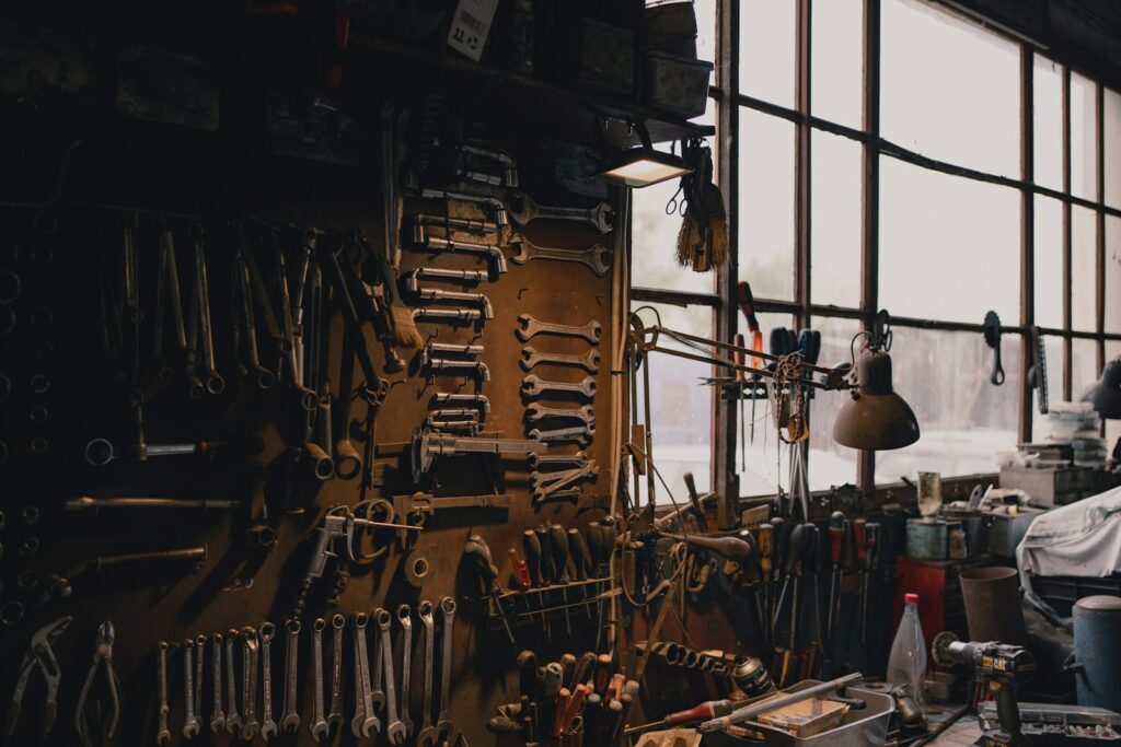 a man sitting in a chair in a room filled with tools